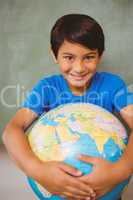 Cute little boy holding globe