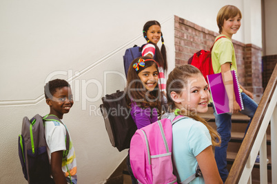 Children walking up stairs in school