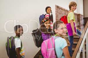 Children walking up stairs in school