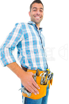 Portrait of smiling handyman wearing tool belt