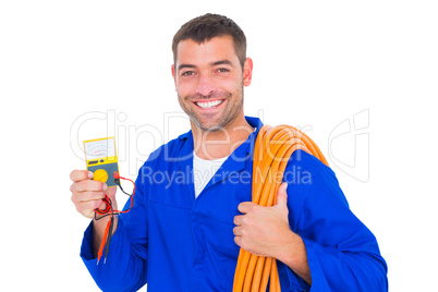 Smiling electrician with rolled wire and multimeter