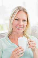 Happy young woman having coffee