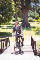 Businessman riding bike in the park