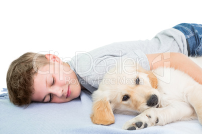 Boy sleeping with dog on blanket