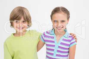 Cute siblings standing arm around on white background