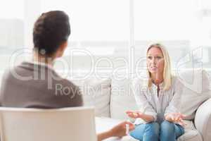 Depressed woman speaking to a therapist