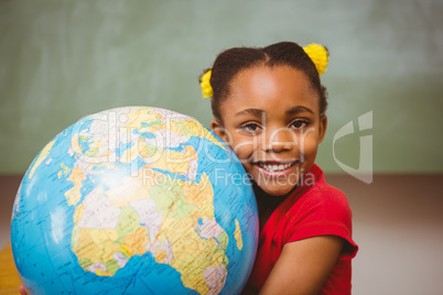 Cute little girl holding globe