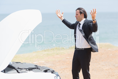 Anger businessman looking at engine