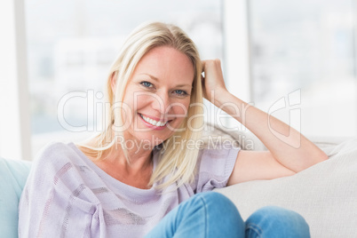 Woman relaxing on sofa in living room