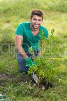 Happy young man gardening for the community