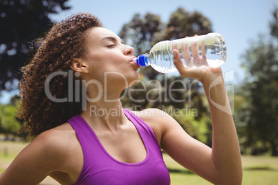 Fit woman taking a drink