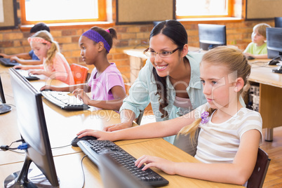 Cute pupils in computer class with teacher