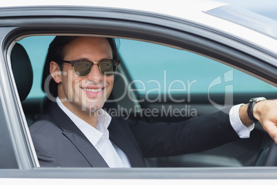 Happy businessman in the drivers seat