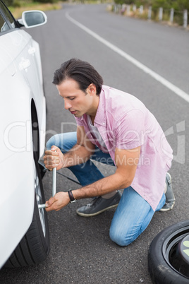 Man changing wheel after a car breakdown