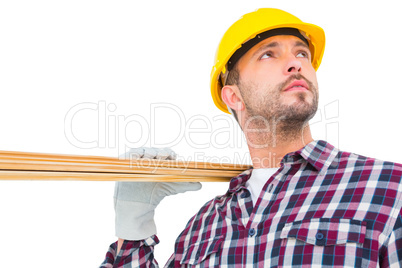 Handyman holding wood planks