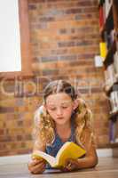 Girl reading book in library