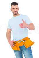 Handyman wearing tool belt with thumbs up