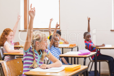 Pupils raising their hands during class