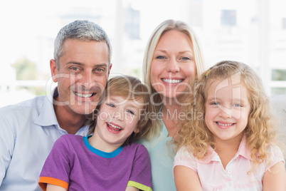 Family smiling together at home