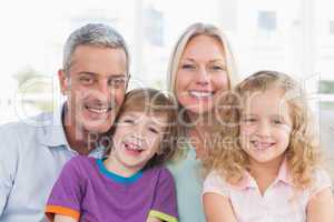 Family smiling together at home