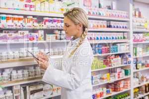 Pharmacy intern writing on clipboard