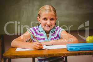 Portrait of cute little girl writing notes