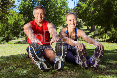 Fit couple stretching in the park