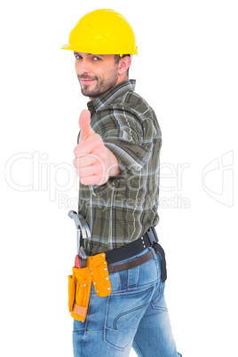 Confident manual worker gesturing thumb up