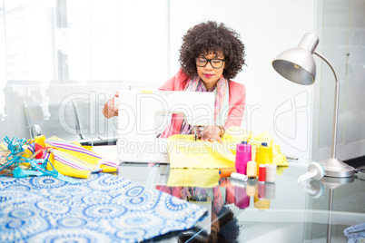 Fashion designer using sewing machine