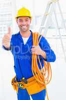 Male technician with wire roll gesturing thumbs up