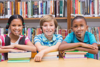 Cute pupils looking at camera in library