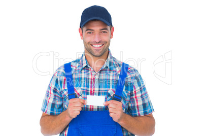 Portrait of happy handyman holding visiting card