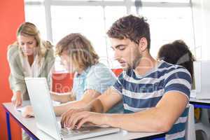 Student using laptop in classroom