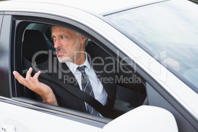Perplexed businessman in the drivers seat