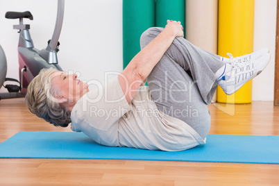 Senior woman working on exercise mat