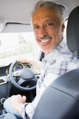 Man smiling while driving