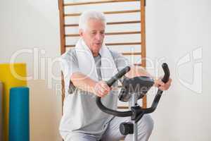 Senior man doing exercise bike