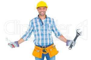 Portrait of handyman holding hand tools