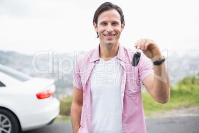 Man smiling and showing key