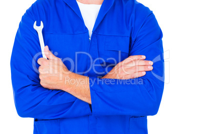 Male mechanic holding spanner on white background