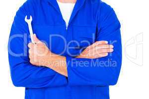 Male mechanic holding spanner on white background