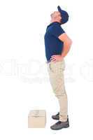 Delivery man suffering from back ache on white background
