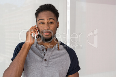 Young casual man using mobile phone