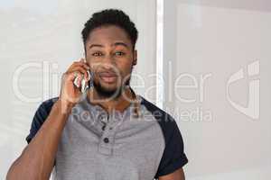 Young casual man using mobile phone