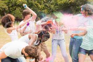 Happy friends throwing powder paint
