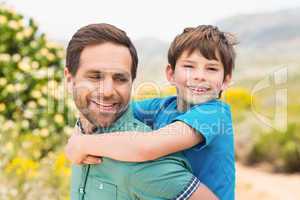 Father and son hiking through mountains