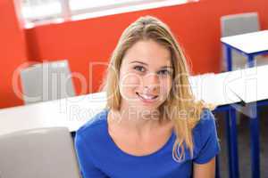 Portrait of smiling female student in classroom