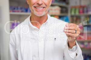 Senior pharmacist holding calling card
