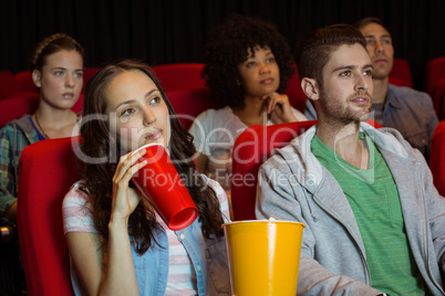 Young friends watching a film