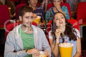 Young couple watching a film